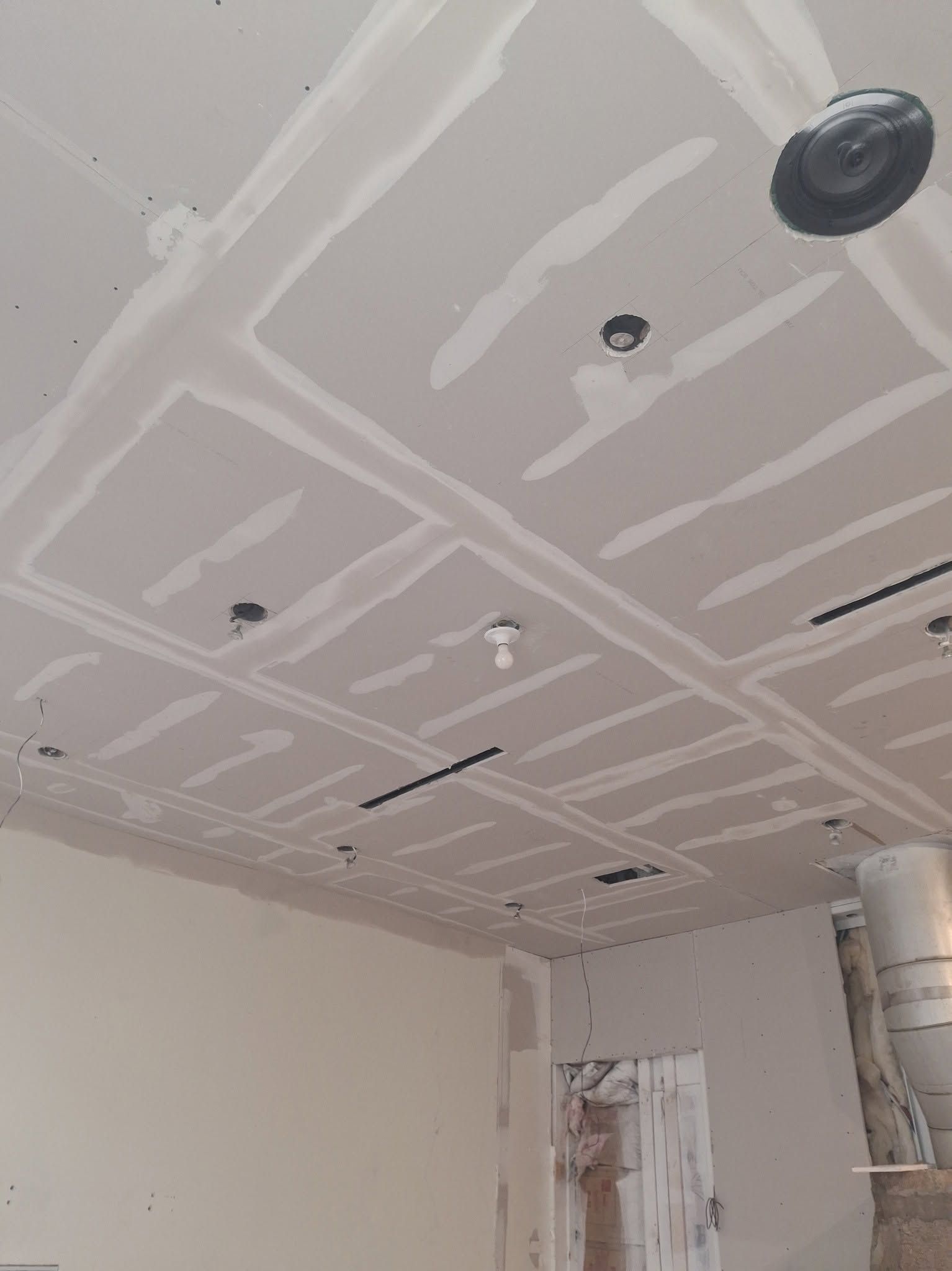 A coffered ceiling in sheetrock, taped and mudded, before paint.